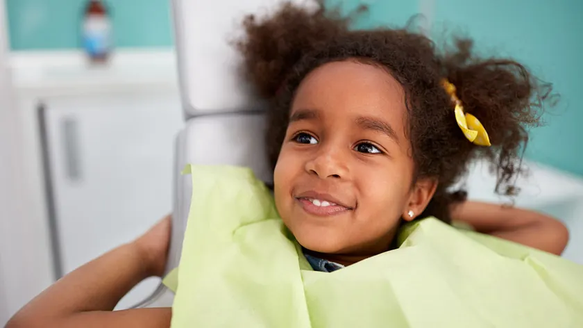 A child in the chair for a six-month check-up.
