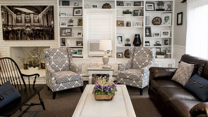 The waiting area at Advanced Dentistry of New Canaan, with upholstered armchairs and framed pictures.